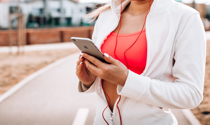 fit girl listening to music on her iphone picjumbo com | Male Value